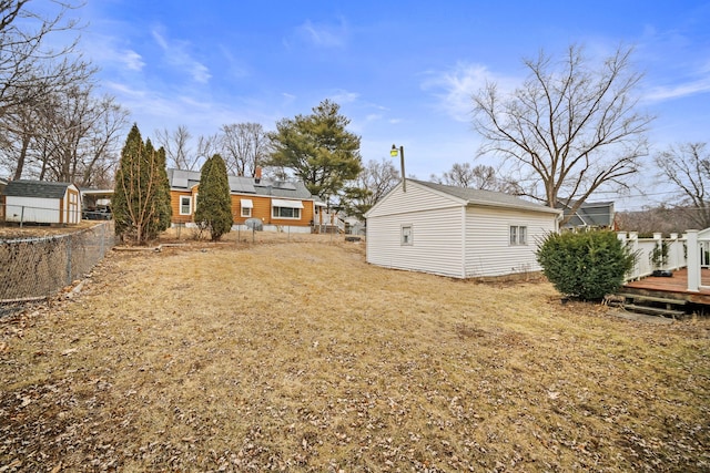 view of yard with a shed and a deck