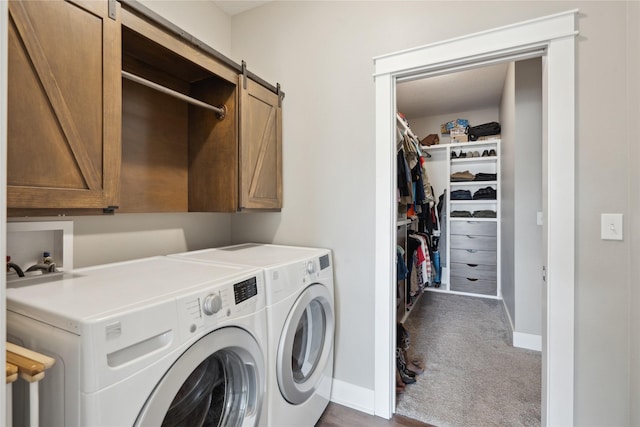 laundry room featuring cabinets, dark colored carpet, separate washer and dryer, and a barn door