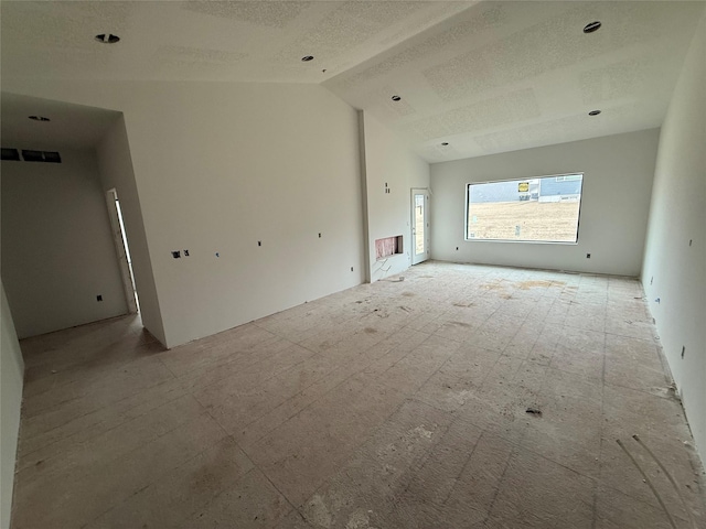 unfurnished living room featuring lofted ceiling