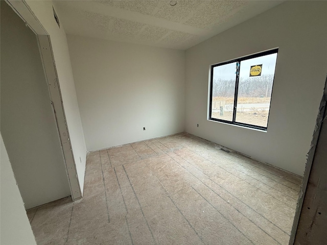 empty room with a textured ceiling