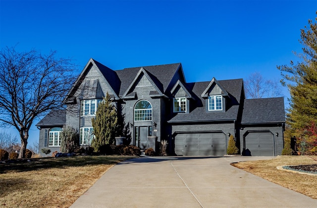 view of front of home with a garage and a front lawn