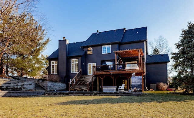 rear view of property featuring a wooden deck, a jacuzzi, a pergola, and a lawn