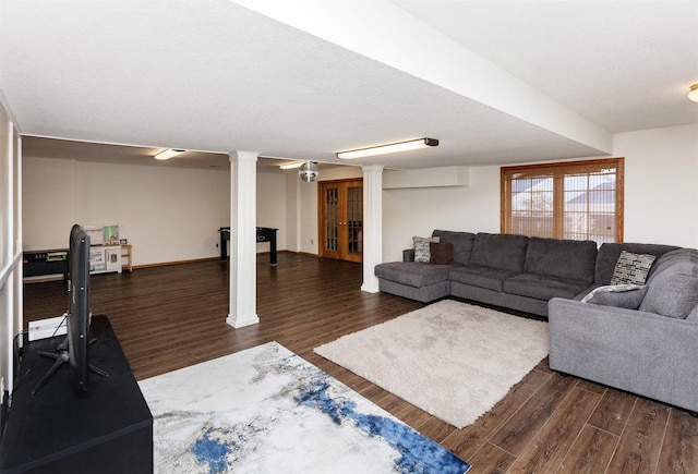 living room with dark wood-type flooring and decorative columns