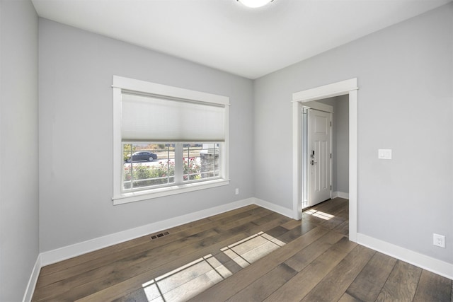 spare room featuring dark hardwood / wood-style floors