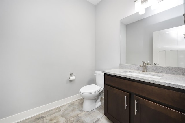 bathroom with vanity, tile patterned floors, and toilet