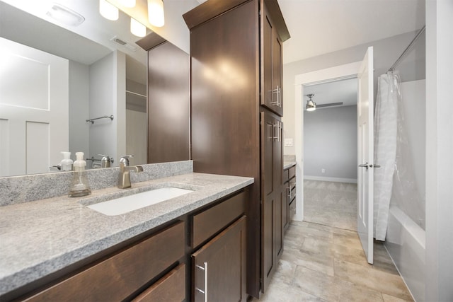 bathroom featuring vanity and shower / bath combo with shower curtain