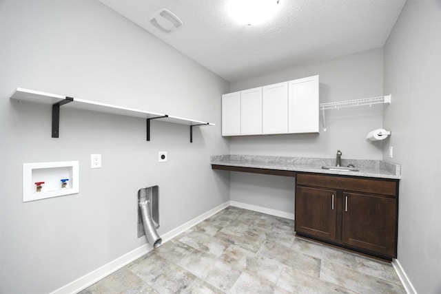 washroom with sink, cabinets, washer hookup, a textured ceiling, and hookup for an electric dryer