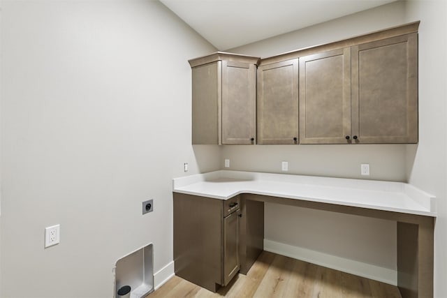 741 Richland Ct, Van Meter, IA 50261 - laundry area featuring electric dryer hookup, light wood-style floors, and cabinet space