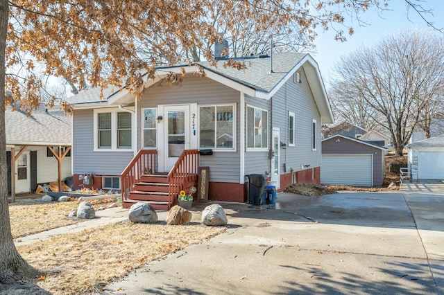 view of front of house with a garage and an outdoor structure