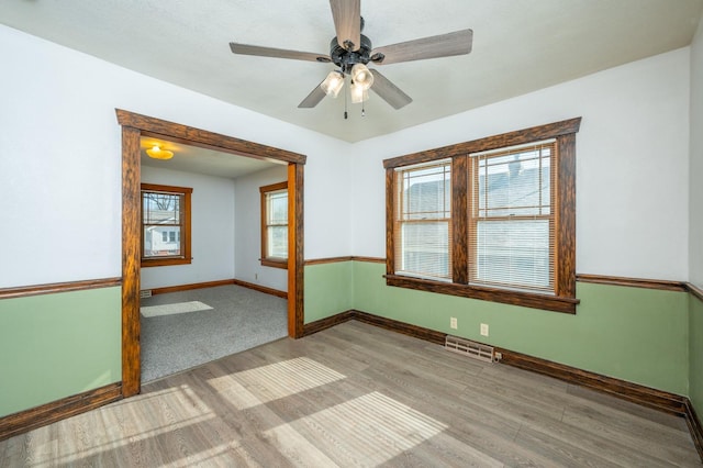 unfurnished room with ceiling fan and light hardwood / wood-style floors