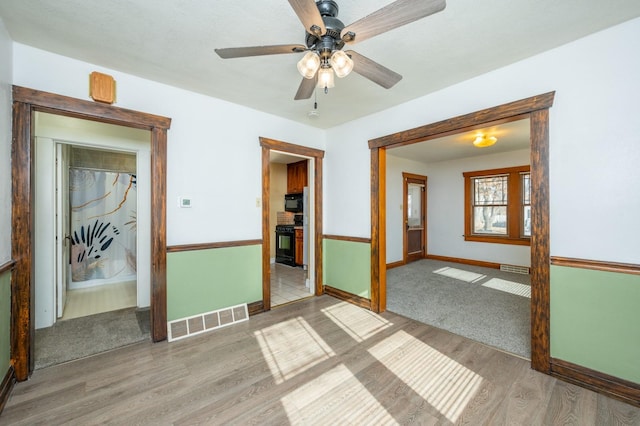 empty room featuring ceiling fan and light hardwood / wood-style floors