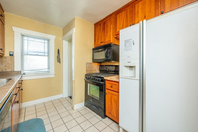 kitchen featuring light tile patterned floors, decorative backsplash, and black appliances