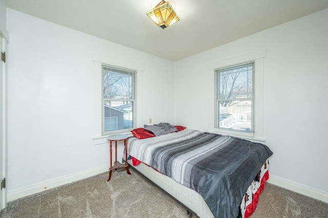 bedroom with carpet flooring and multiple windows