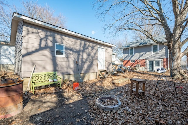 rear view of house featuring an outdoor fire pit