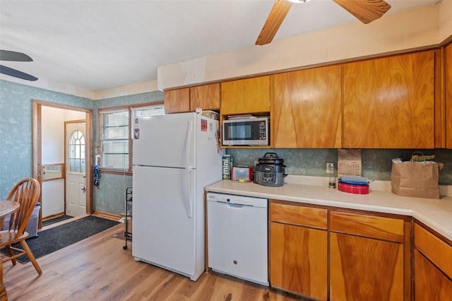 kitchen featuring white appliances, light hardwood / wood-style floors, decorative backsplash, and ceiling fan