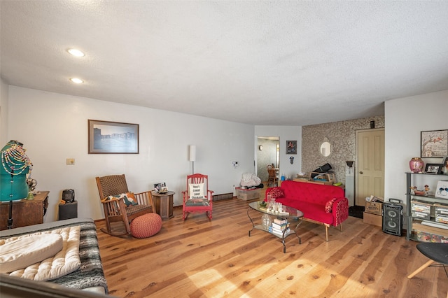 living room with hardwood / wood-style flooring and a textured ceiling