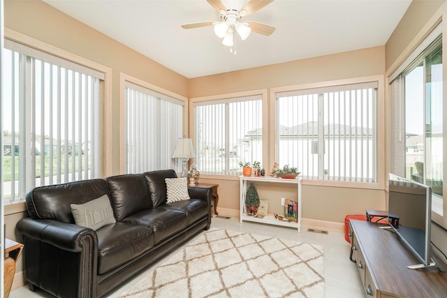 sunroom / solarium featuring ceiling fan and a healthy amount of sunlight