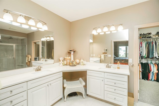 bathroom featuring walk in shower, vanity, and tile patterned flooring