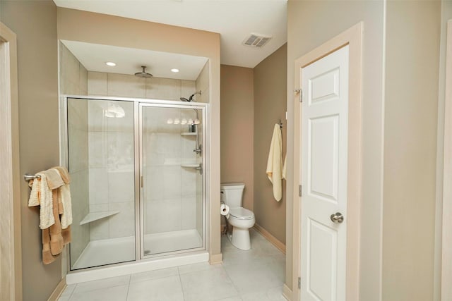 bathroom featuring an enclosed shower, tile patterned floors, and toilet