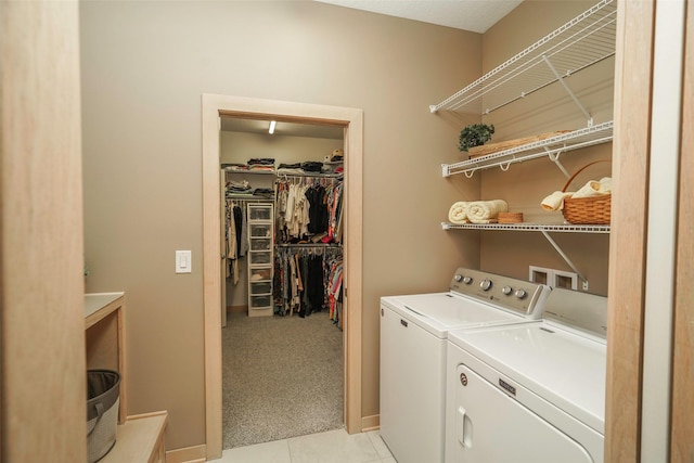 clothes washing area with washing machine and dryer and light carpet