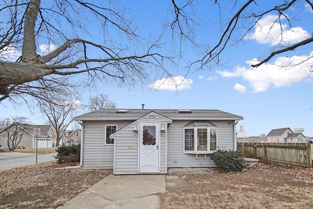 bungalow-style home featuring fence