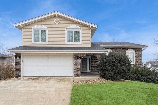 split level home with a garage and a front lawn