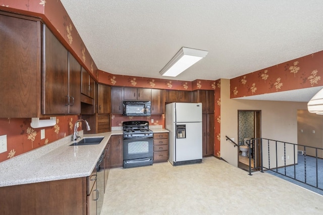 kitchen featuring dark brown cabinets, sink, a textured ceiling, and black appliances