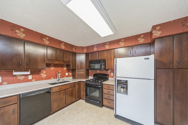 kitchen with dark brown cabinetry, sink, a textured ceiling, and black appliances