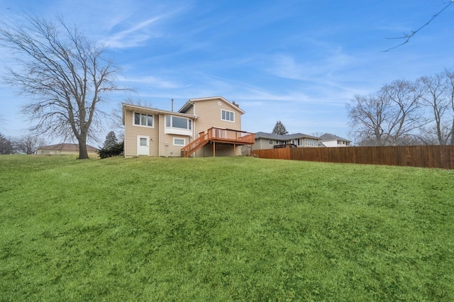 back of property featuring a yard and a deck