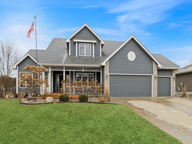 view of front of home featuring a garage, a front lawn, and a porch