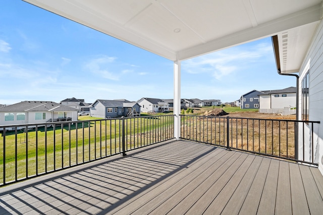 wooden terrace featuring a residential view and a yard