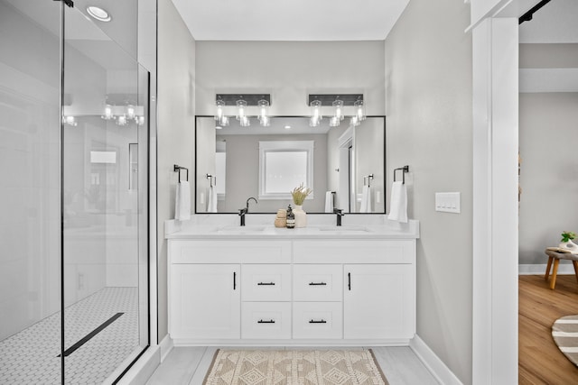 bathroom with vanity and a shower with shower door