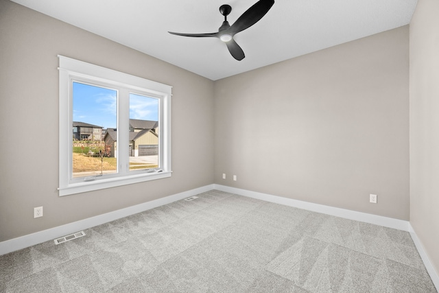 carpeted empty room featuring ceiling fan