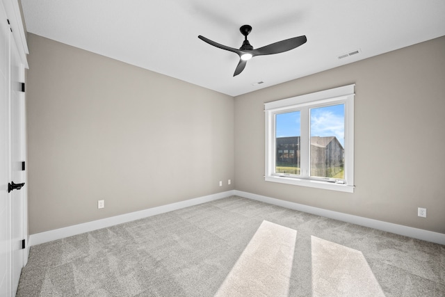 unfurnished room with a ceiling fan, carpet, visible vents, and baseboards