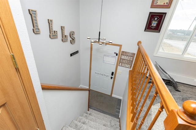 stairs with baseboards and an inviting chandelier