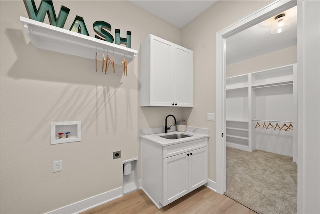 washroom featuring sink, cabinets, hookup for a washing machine, electric dryer hookup, and light hardwood / wood-style floors