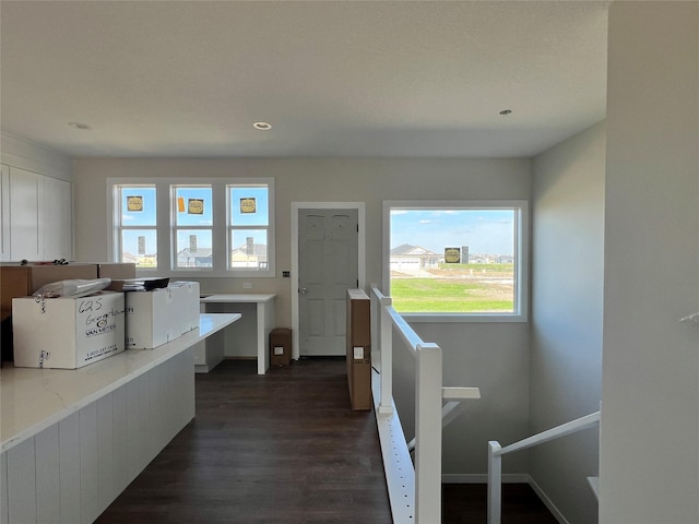 hallway featuring baseboards, an upstairs landing, dark wood finished floors, and recessed lighting