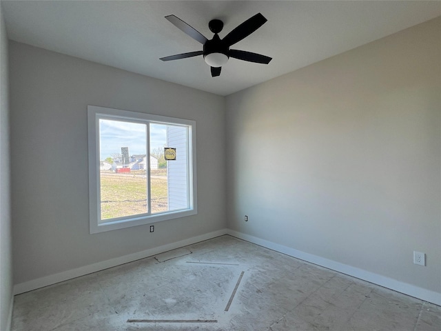 unfurnished room with baseboards and a ceiling fan