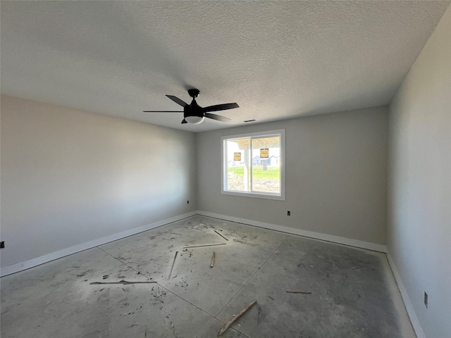 empty room with baseboards, ceiling fan, and a textured ceiling