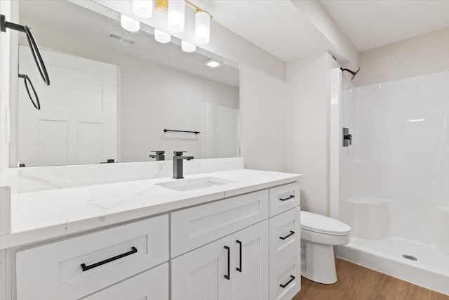 625 NW Georgetown Dr, Waukee, IA 50263 - bathroom featuring vanity, wood finished floors, and a shower