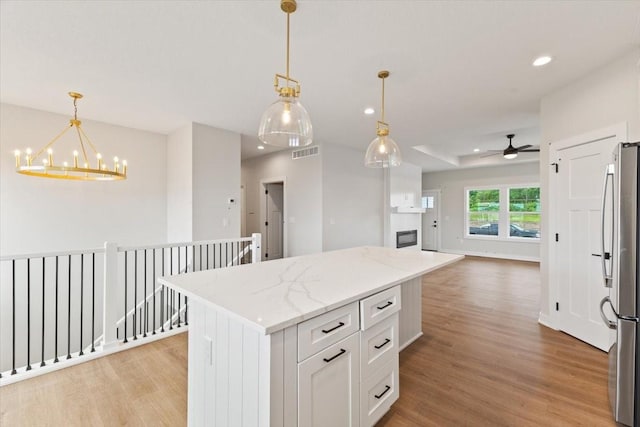 625 NW Georgetown Dr, Waukee, IA 50263 - kitchen featuring freestanding refrigerator, a chandelier, light wood-type flooring, ceiling fan, and recessed lighting