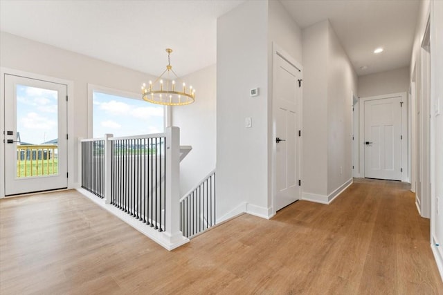 625 NW Georgetown Dr, Waukee, IA 50263 - hall featuring an upstairs landing, wood finished floors, a chandelier, and recessed lighting