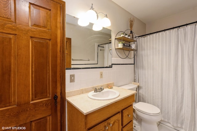 bathroom with vanity, curtained shower, tile walls, and toilet