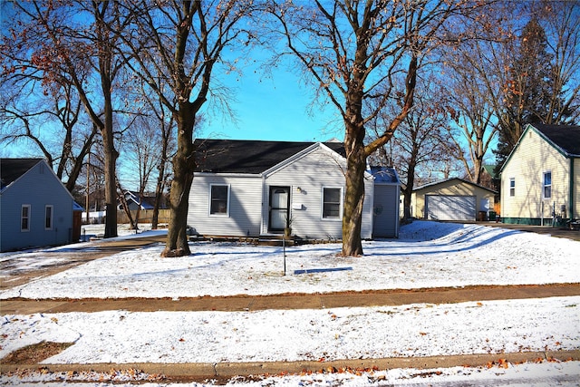 view of front of property featuring a garage and an outdoor structure