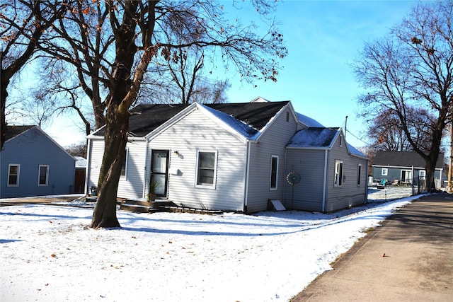 view of snow covered rear of property