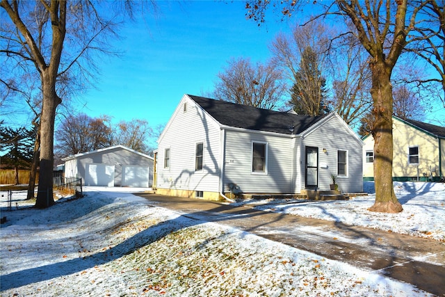 view of front of house with a garage and an outdoor structure