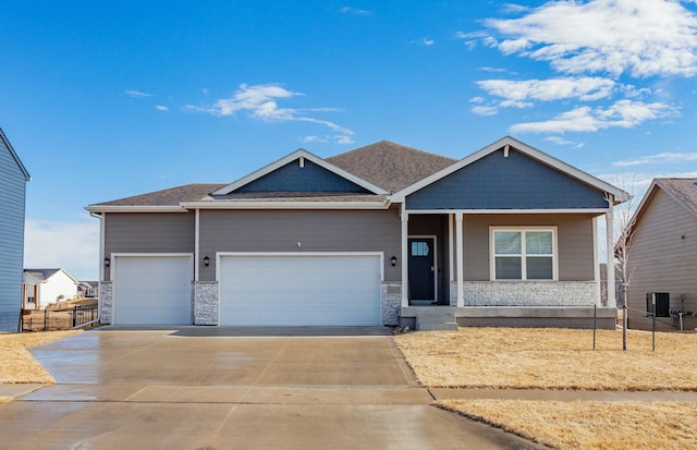 craftsman house featuring a garage and central AC