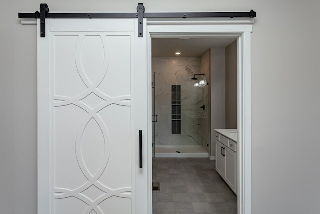 bathroom with vanity and a tile shower