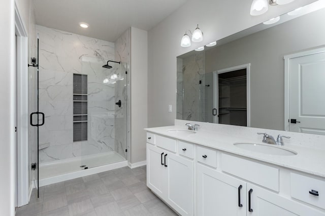 bathroom featuring vanity and a shower with door