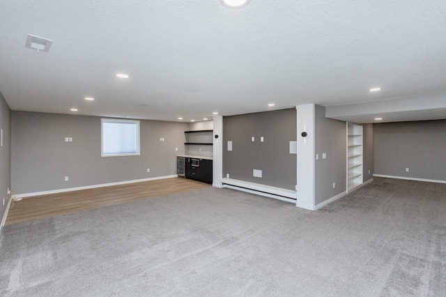 unfurnished living room with a baseboard radiator, carpet floors, and a textured ceiling